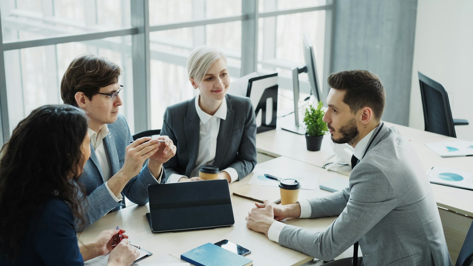 Business colleagues discussing a project together around a conference table