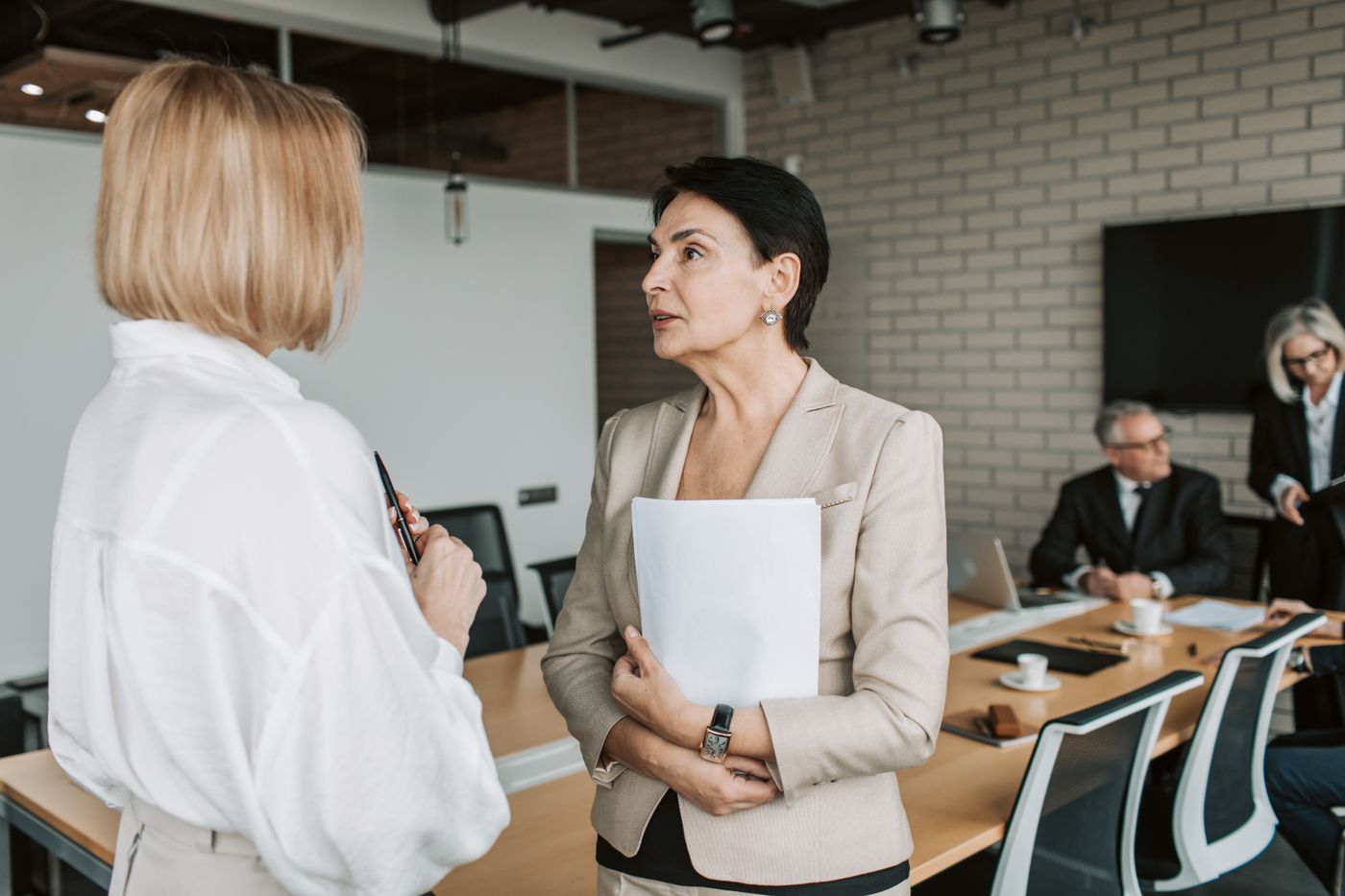 Two business professionals in conversation during a meeting