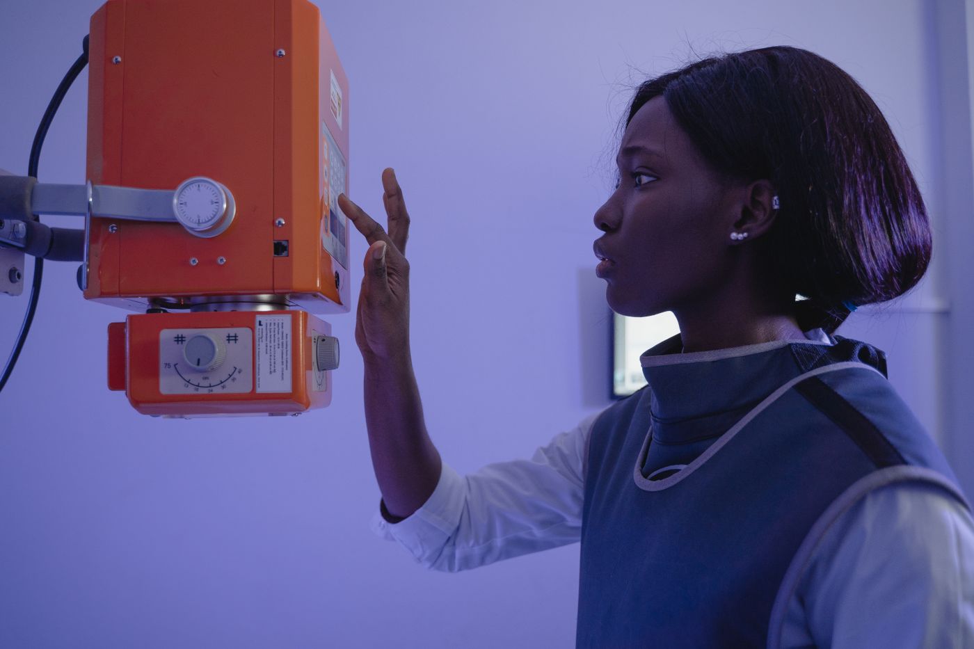 Radiologic technologist adjusting imaging equipment before an exam